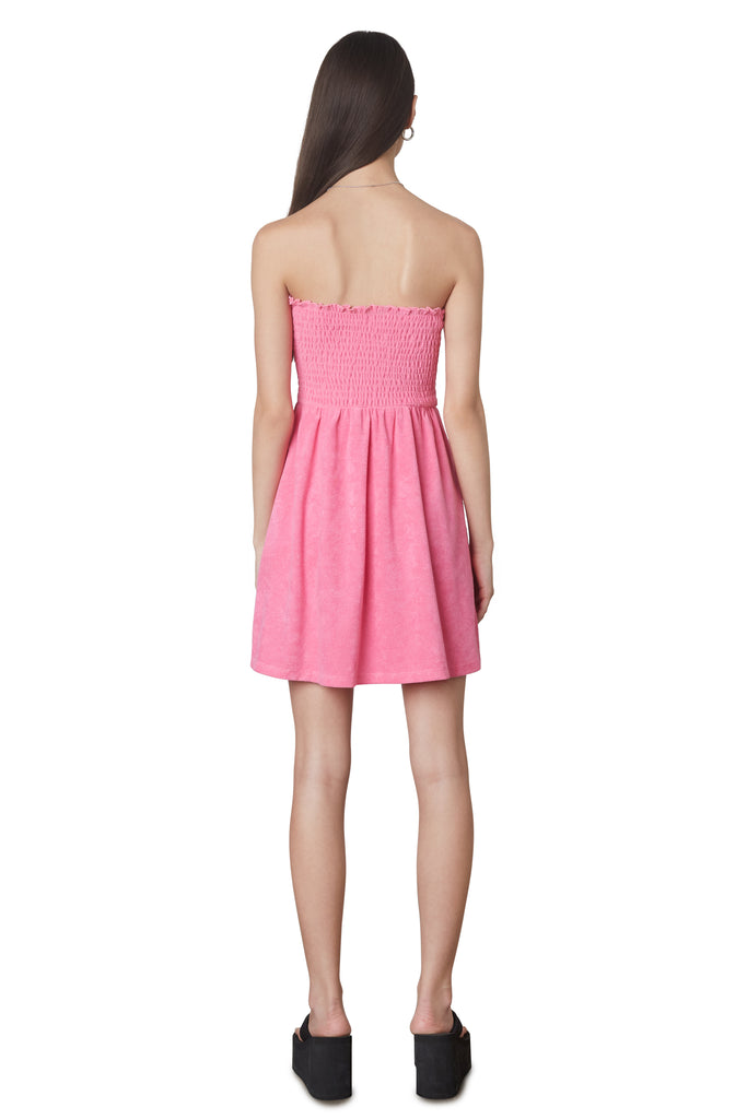 Smocked Terry Dress in Pink: Terrycloth mini strapless dress featuring a smocked bust and hidden pockets. Unlined. Back view.