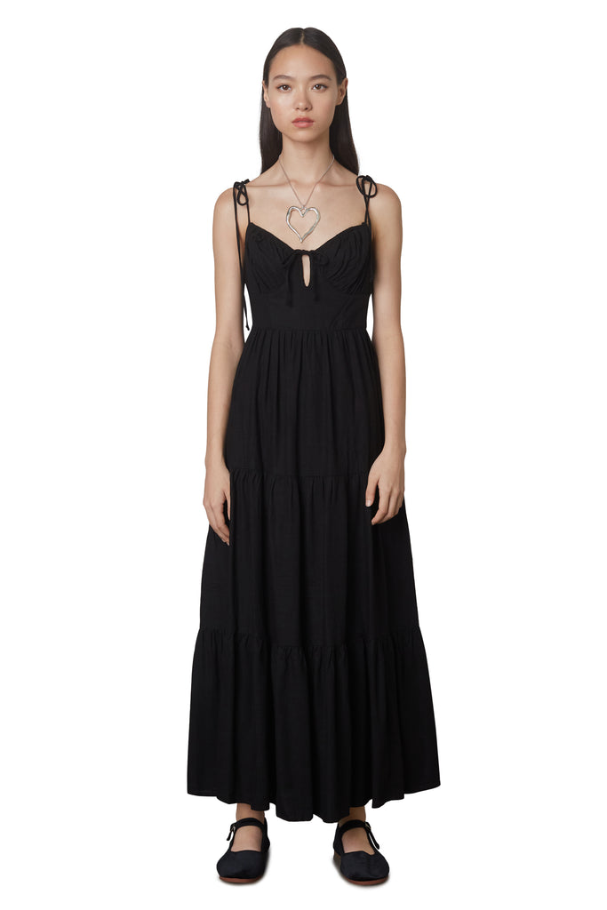 Aimee Dress in Black: Linen blend maxi dress festering a tiered skirt, self tie straps, and back zipper closure. Front view