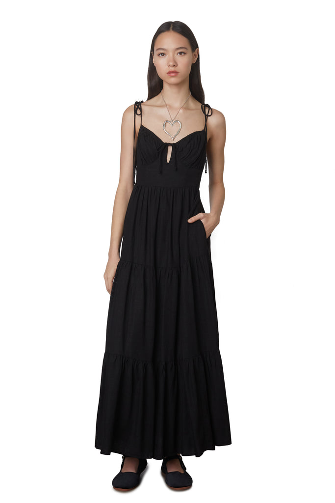 Aimee Dress in Black: Linen blend maxi dress festering a tiered skirt, self tie straps, and back zipper closure. Front view 2