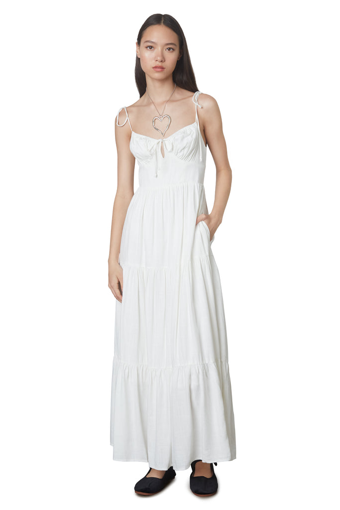 Aimee Dress in White: Linen blend maxi dress festering a tiered skirt, self tie straps, and back zipper closure. Front view 2