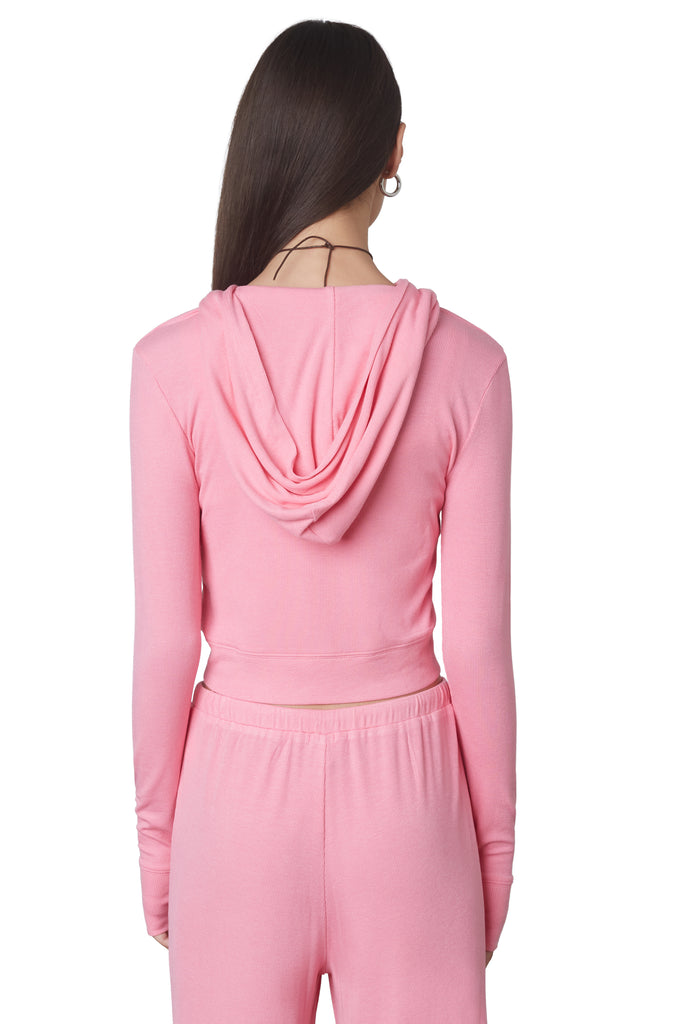 Cropped Hacci Hoodie in Bubble Gum: Form fitting cropped ribbed zip up hoodie with double zipper detail and thumb holes. Back view.