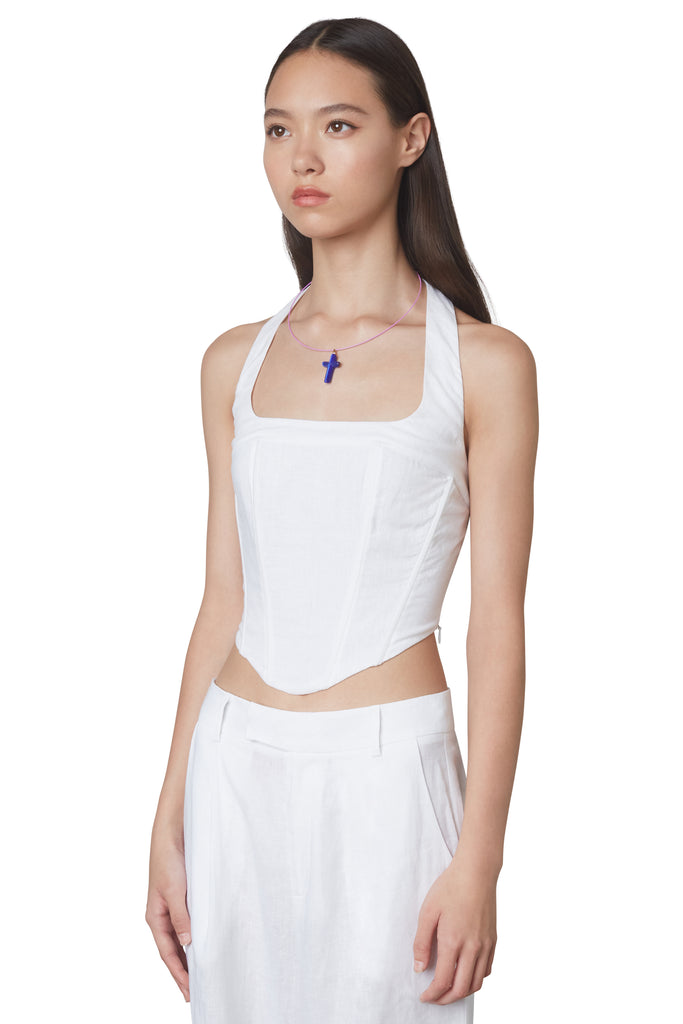 Mia Corset in White: Halterneck linen corset with boning and side zipper closure. Side view.