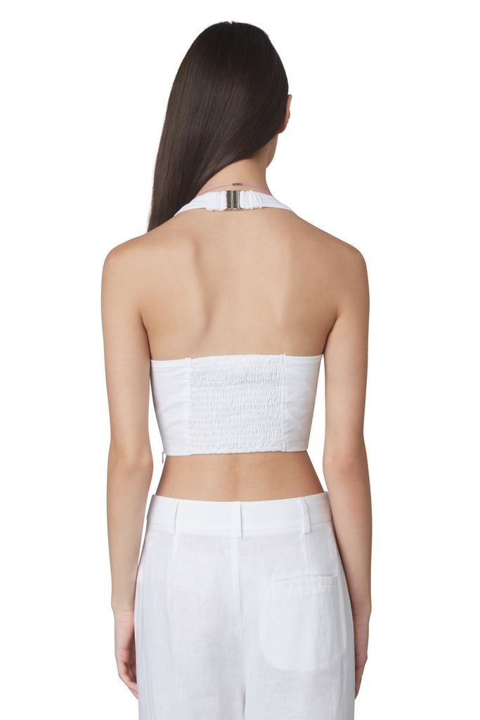 Mia Corset in White: Halterneck linen corset with boning and side zipper closure. Back view.