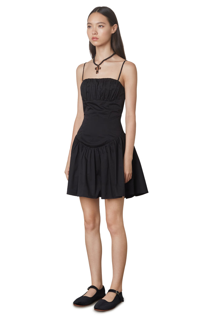 Puglia Dress in black: Poplin drop waist corset mini dress featuring a ruching detail at bust. Fully lined. side view