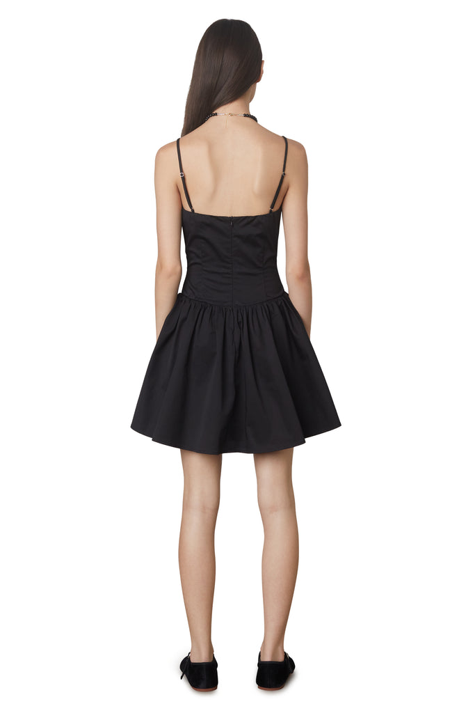 Puglia Dress in black: Poplin drop waist corset mini dress featuring a ruching detail at bust. Fully lined. back view