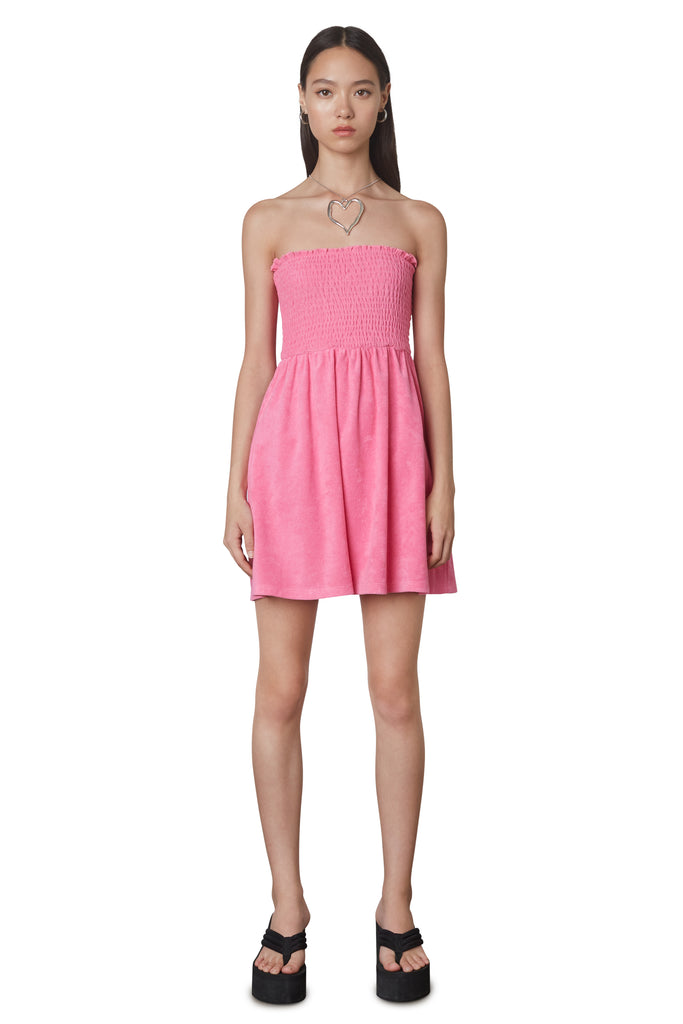 Smocked Terry Dress in Pink: Terrycloth mini strapless dress featuring a smocked bust and hidden pockets. Unlined. Front view.