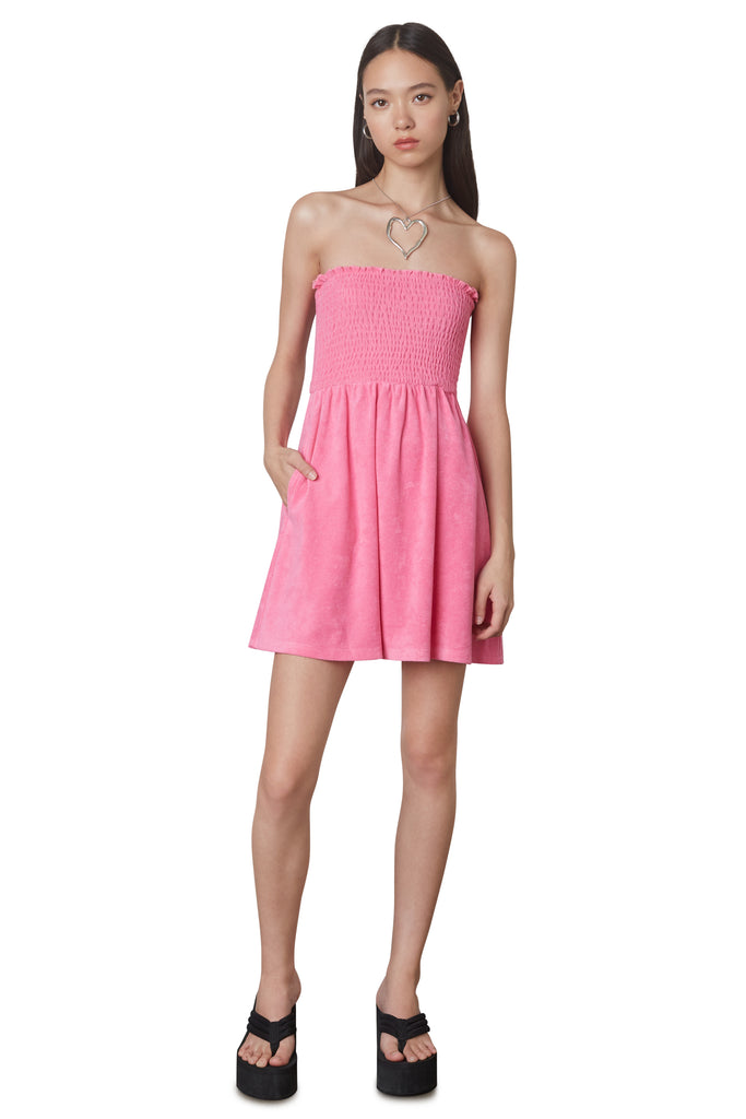 Smocked Terry Dress in Pink: Terrycloth mini strapless dress featuring a smocked bust and hidden pockets. Unlined. Front view 2.