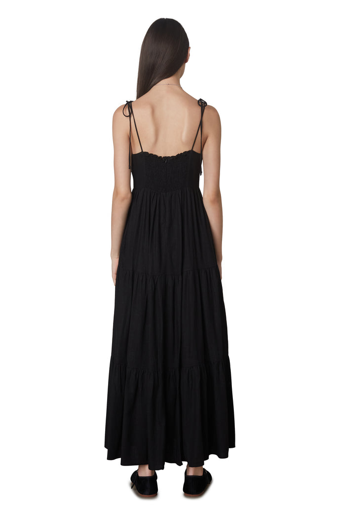 Aimee Dress in Black: Linen blend maxi dress festering a tiered skirt, self tie straps, and back zipper closure. Back view