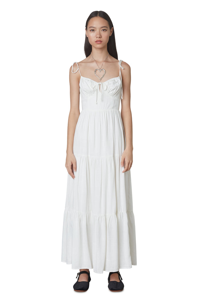 Aimee Dress in White: Linen blend maxi dress festering a tiered skirt, self tie straps, and back zipper closure. Front view