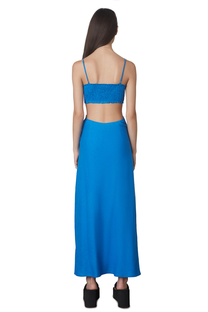 Chamomile Dress in cobalt blue: Ankle length linen dress featuring cut out detailing with a smocked back and adjustable straps. Fully lined. back view