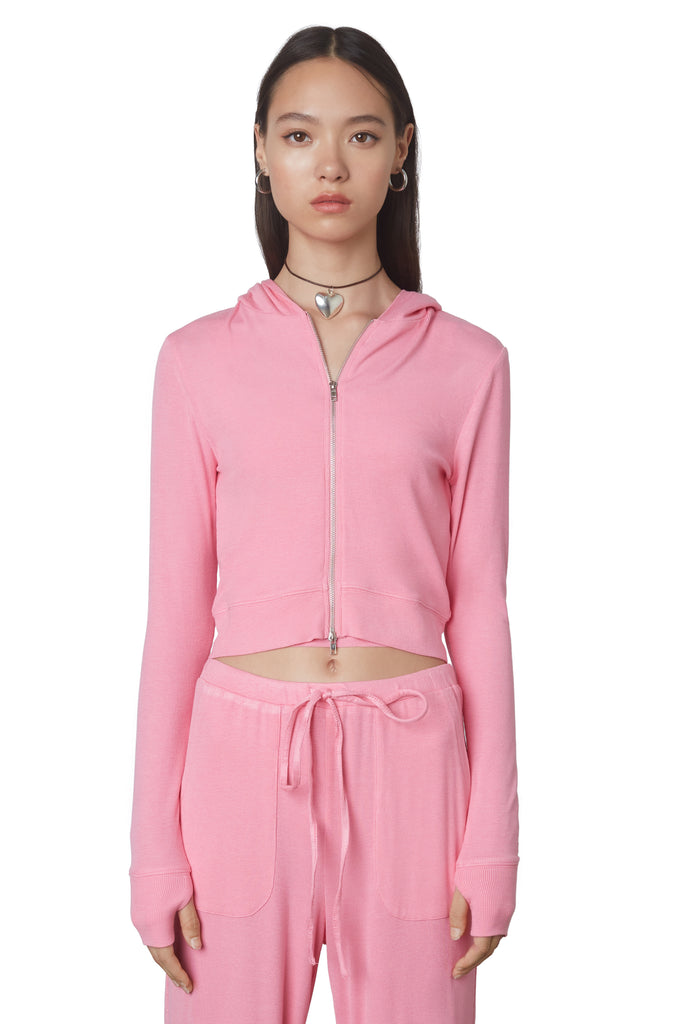 Cropped Hacci Hoodie in Bubble Gum: Form fitting cropped ribbed zip up hoodie with double zipper detail and thumb holes. Front view.