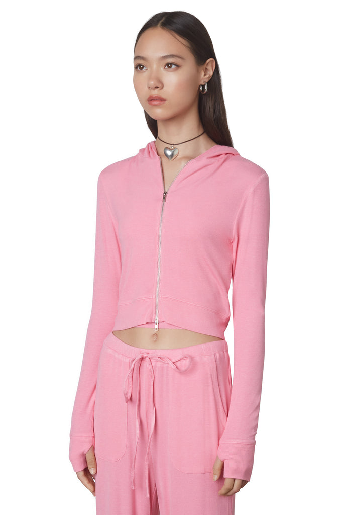 Cropped Hacci Hoodie in Bubble Gum: Form fitting cropped ribbed zip up hoodie with double zipper detail and thumb holes. Side view.