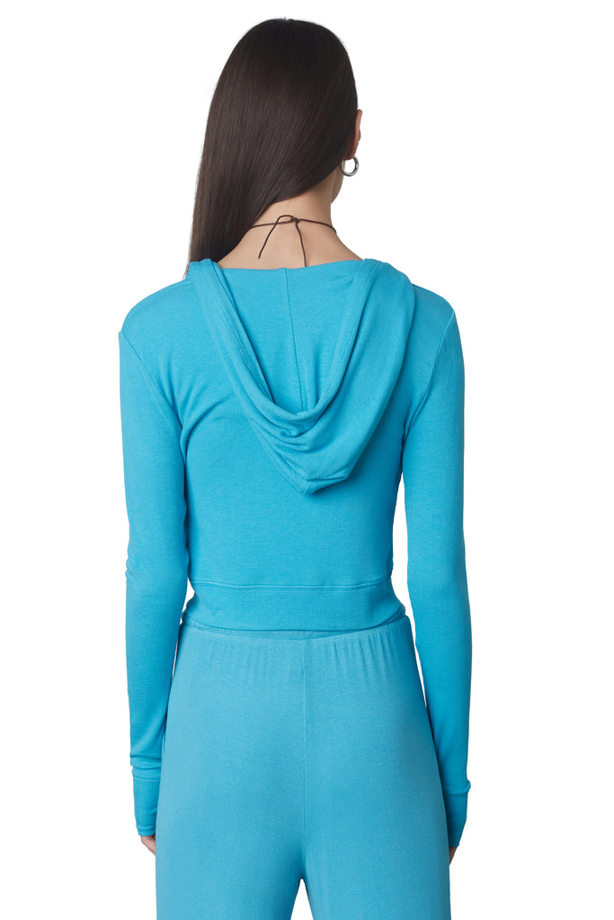 Cropped Hacci Hoodie in Capri: Form fitting cropped ribbed zip up hoodie with double zipper detail and thumb holes. Back view.