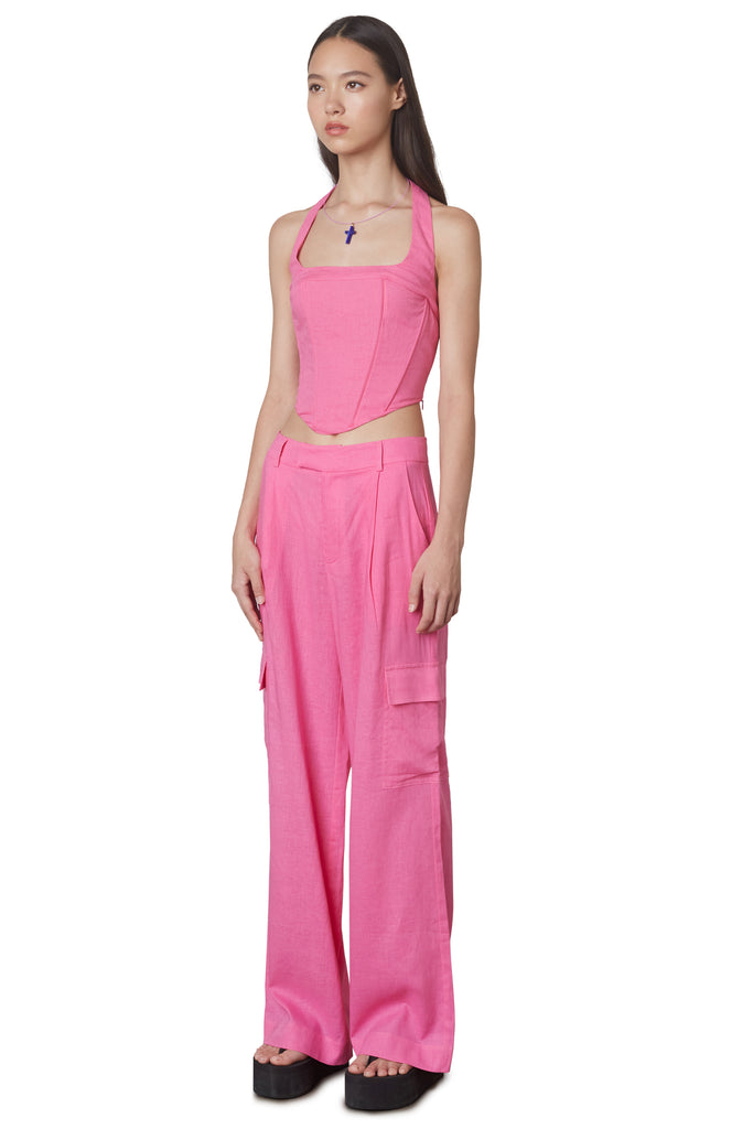 Campari Pant in Pink: Mid-rise linen trouser featuring a wide leg and cargo pocket detailing. Unlined. Side View.