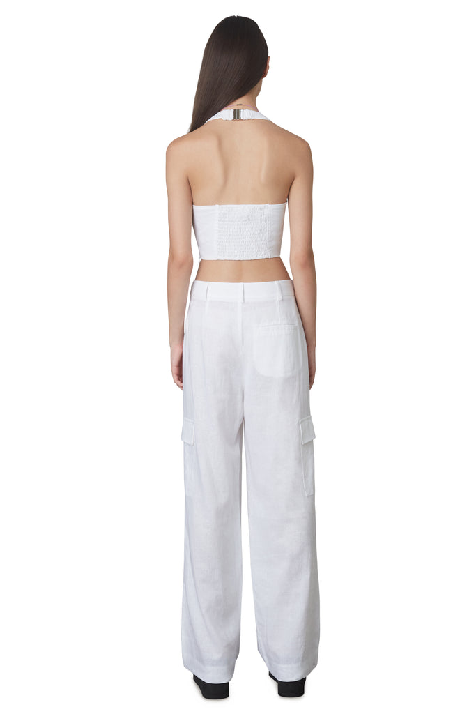 Campari Pant in White: Mid-rise linen trouser featuring a wide leg and cargo pocket detailing. Unlined. Back View.