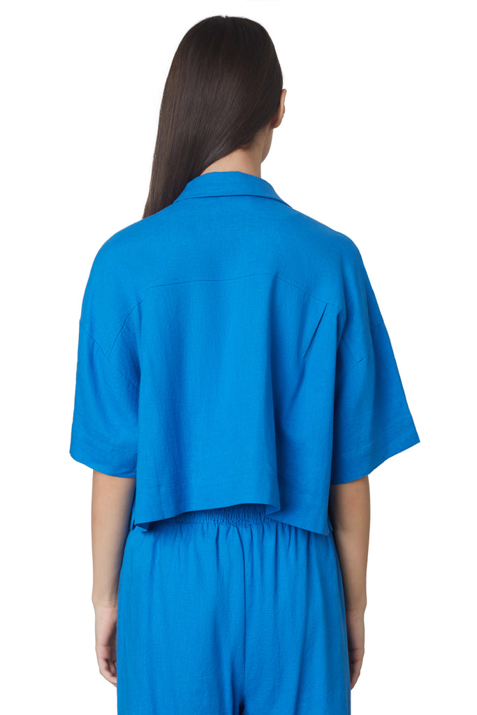 cropped boxy shirt in cobalt blue: Cropped linen boxy shirt featuring shell buttons back view
