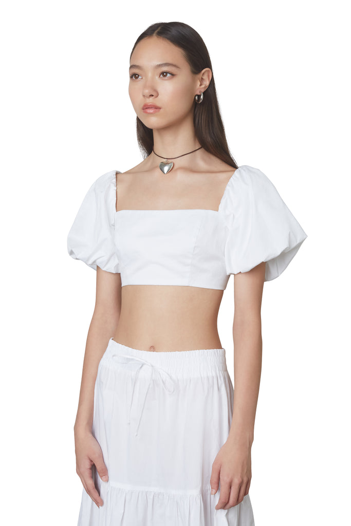 julianne top in white: Puff sleeve fitted crop top with hook and eye closures at back. Fully lined. side view